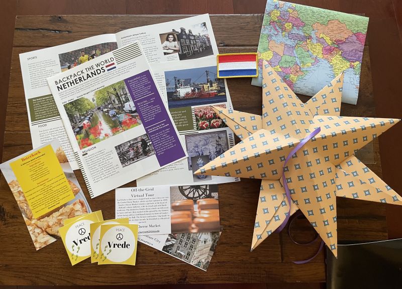 Backpack the World educational subscription box, with educational pamphlet, map, paper star craft, and more