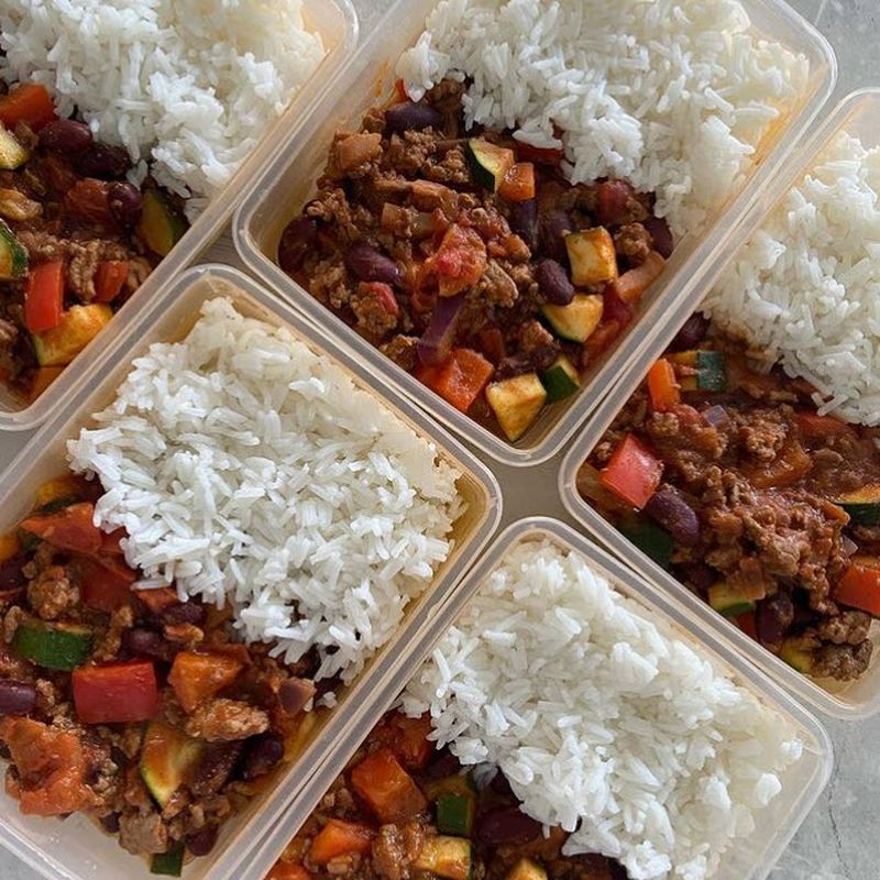 Glass dishes containing rice and chili con carne