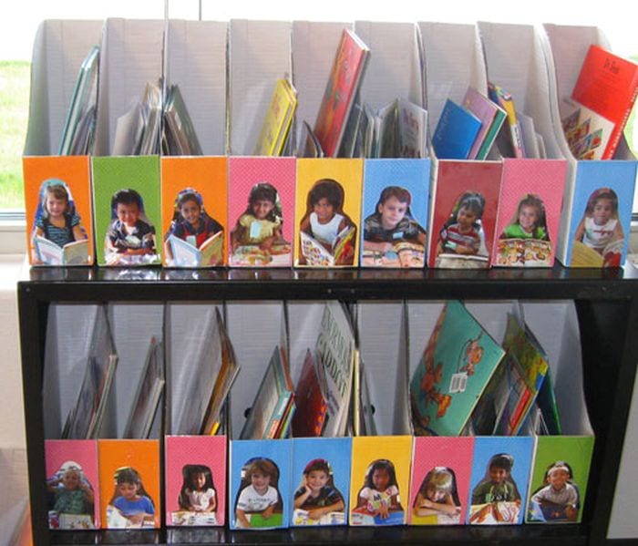 Cardboard magazine holders with children's photos on the front