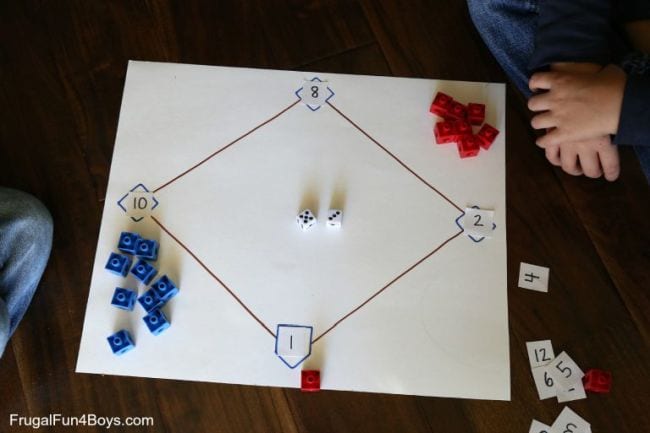 Baseball diamond drawn on a large piece of paper, with numbers at each base and red and blue markers 