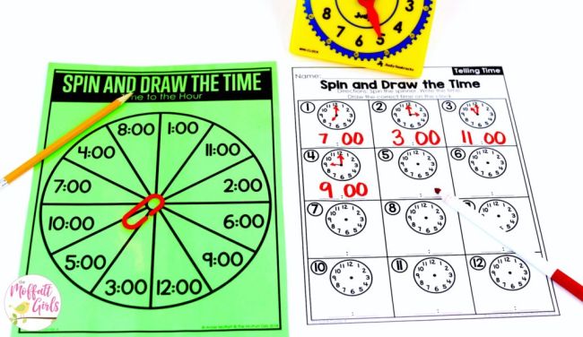 Spinner circle with various times in the wedges, and a paperclip spinner, plus a worksheet for drawing times on a clock face and a plastic toy clock