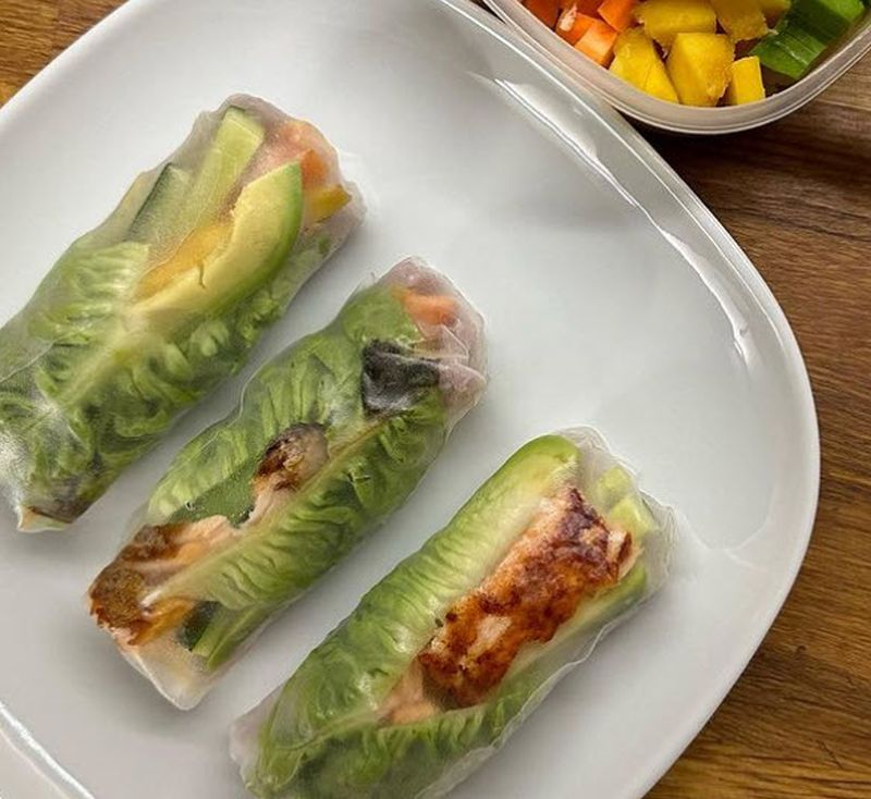 Three veggie-filled summer rolls on a white plate, made for teacher lunches