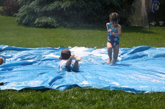 Kids playing on a water slide
