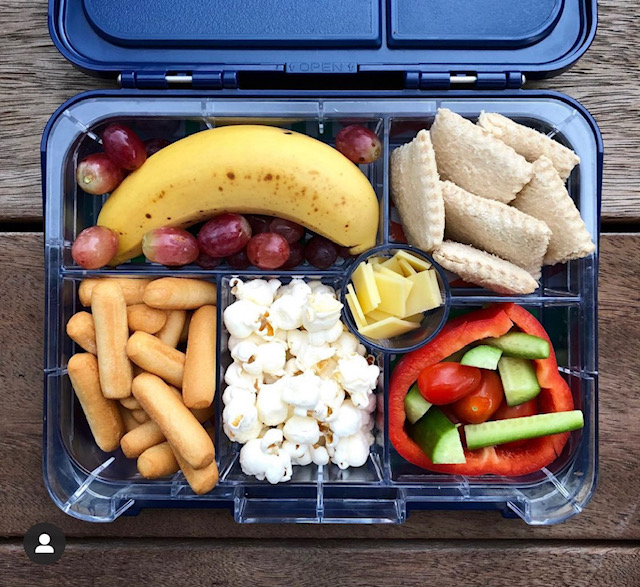 Bento box with crimped sandwiches and snacks
