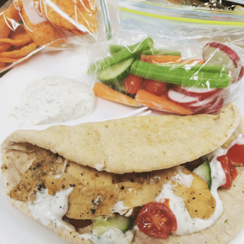 Grilled chicken gyro in a pita, with a baggie of mixed veggies